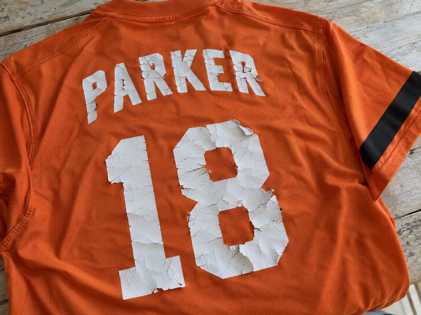 Example of cracked name and number printing on a sports jersey